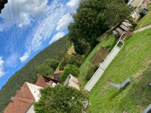 Blick auf einen grünen Hügel mit Häusern und Bäumen in der Unterkunft Ferienhaus Bärbelstein Barbarossa in Erlenbach