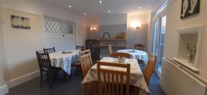 a dining room with two tables and chairs at Shenandoah House in Margate