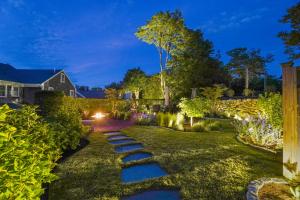 a garden at night with stepping stones at The Martin in Nantucket