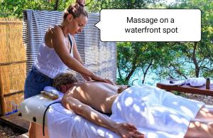 a woman is giving a man a massage on a hot tub at KEROMOUSSI SEASIDE BOUTIQUE HOTEL - Adult only in Meganisi