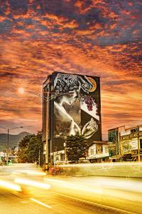 a painting of a clock on the side of a street at HOTEL CAVALTA in Medellín
