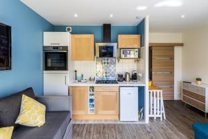 a small kitchen and living room with a couch at Dreams and Sensations in Torcy