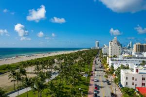 a view of the beach and buildings and palm trees at Leslie Hotel Ocean Drive in Miami Beach