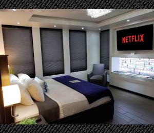 a bedroom with a king sized bed and a television at The Condo (by Modern Apartments) in Rosarito