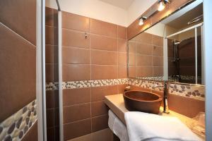 a bathroom with a sink, toilet and bathtub at Hotel Beau Rivage in Algajola