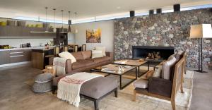 a living room with a couch and a fireplace at The Vines Resort & Spa in Los Sauces