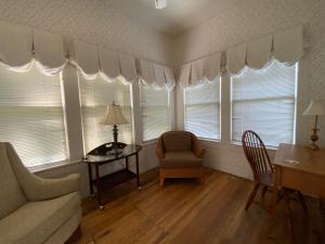 a living room with windows and a couch and a table at Inn On The River in Glen Rose