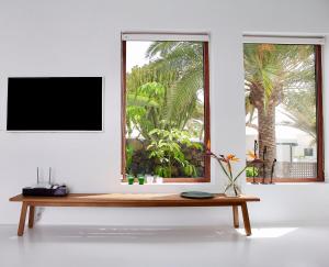 a wooden bench in a room with a window at Unique, Stylish & Calm El Estanque by the Sea, Adults Only in Costa Teguise