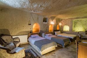 A bed or beds in a room at Atilla's Cave Hotel