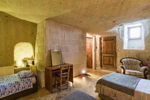 A bed or beds in a room at Atilla's Cave Hotel