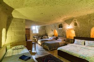 A bed or beds in a room at Atilla's Cave Hotel