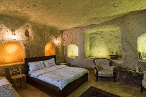 A bed or beds in a room at Atilla's Cave Hotel