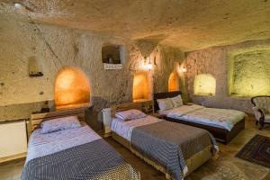 A bed or beds in a room at Atilla's Cave Hotel