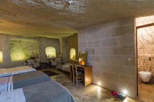 A bed or beds in a room at Atilla's Cave Hotel