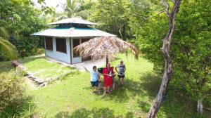 a group of people standing in front of a small house at WINDOWS AT THE SEA in San Juanillo