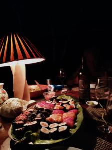 a plate of sushi on a table with a lamp at WINDOWS AT THE SEA in San Juanillo