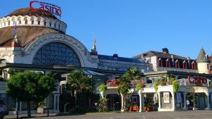 a building with a sign on the top of it at H&ocirc;tel du Palais in &Eacute;vian-les-Bains