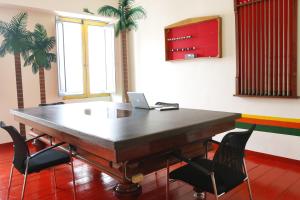 a conference room with a table with a laptop on it at Golden Frog Manizales in Manizales