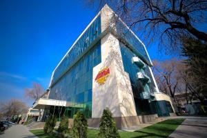 a building with a sign on the side of it at Astra Hotel in Almaty