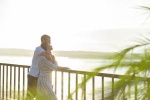 a man and a woman standing next to the beach at Adiwana Warnakali Resort in Nusa Penida