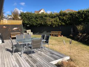 a table and chairs on a deck in a yard at Anglers Retreat in Lake Tekapo