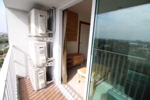 a balcony of a building with a view of the city at Lee Place Phatthanakan Condo in Bangkok +21 photos