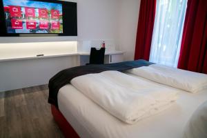 Ένα ή περισσότερα κρεβάτια σε δωμάτιο στο Hotel Andante Rust