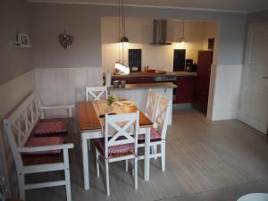 a kitchen and dining room with a table and chairs at Hansenhof in Kappeln