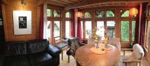 a living room with a wooden table and chairs at Valea Vinului Suite in Vişeu de Sus +21 photos