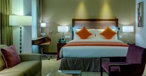 a hotel room with a bed and a couch at Crowne Plaza Madinah, an IHG Hotel in Al Madinah