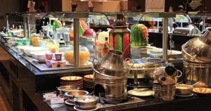a buffet line with dishes and pots and pans at Crowne Plaza Madinah by IHG in Medina +78 photos