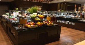 a buffet line with fruits and other food on a table at Crowne Plaza Madinah by IHG in Medina