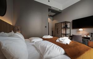 a hotel room with a bed with towels on it at Karl Johan Hotel in Oslo
