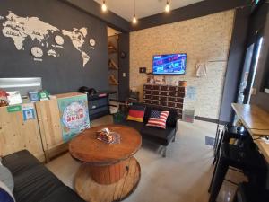 a room with a table and a couch and a tv at Backpack Home 497-No.2 in Jincheng