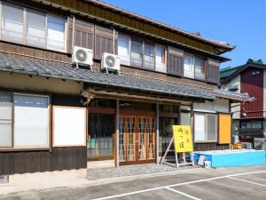 a building with speakers on top of it at Tabist Sakipo Minamichita in Morozaki