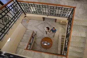 two people standing on the stairs of a house at Hotel Nuvò in Naples