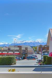 a view of a parking lot with mountains in the background at Bella Vista Motel Lake Wanaka in Wanaka