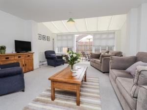 a living room with a couch and a coffee table at 60 Galley Hill View in Bexhill