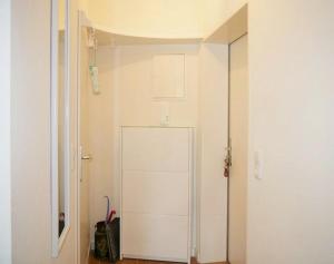 a hallway with a white door in a room at Seedeich Apartment in Cuxhaven +6 photos