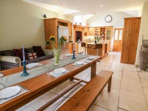 a kitchen and living room with a wooden table at Manor House in Accrington