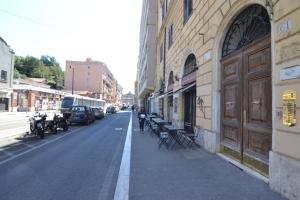 a person walking down a street next to a building at Glamour Spanish Steps in Rome +29 photos