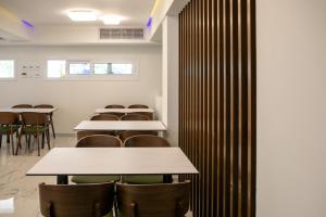 a row of tables and chairs in a room at Best Western Plus Larco Hotel in Larnaka +37 photos