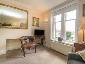 a living room with a desk and a mirror at 1 Abbey Court in Sherborne