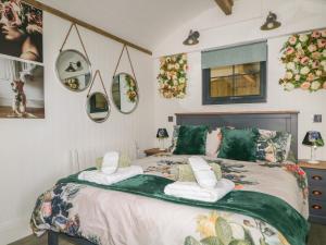 a bedroom with a large bed with towels on it at High Rigg Shepherd's Hideaway in Brampton