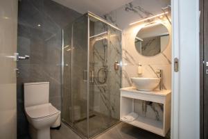 a bathroom with a shower and a toilet and a sink at Best Western Plus Larco Hotel in Larnaca