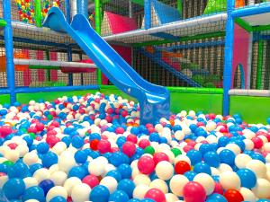 a blue slide in a pile of balls at Prawdzic Family Resort & Wellness in Gdańsk