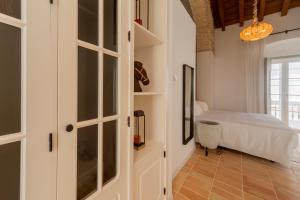 a bedroom with white cabinets and a bed at Albariza Hotel Boutique in Sanlúcar de Barrameda