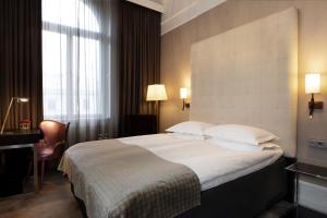 Postel nebo postele na pokoji v ubytování Elite Plaza Hotel