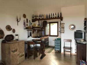 a room with a desk and a table and a tv at Villa Relax in Santa Lucia