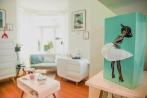 a picture of a woman in a dress in a living room at Bouquet des dunes - with private parking - completely renovated in De Panne